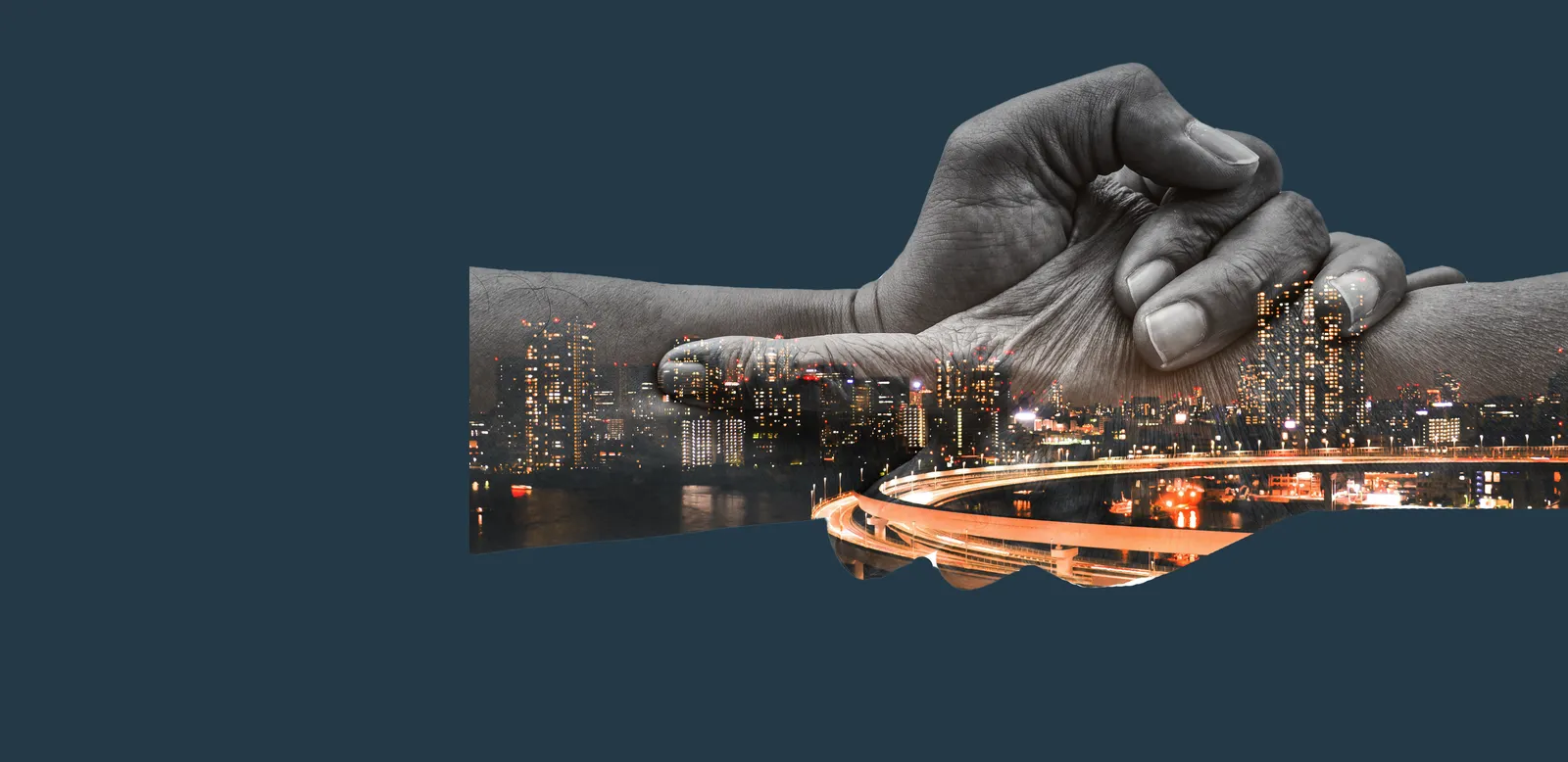 Two hands clasped, a city skyline at night inside them